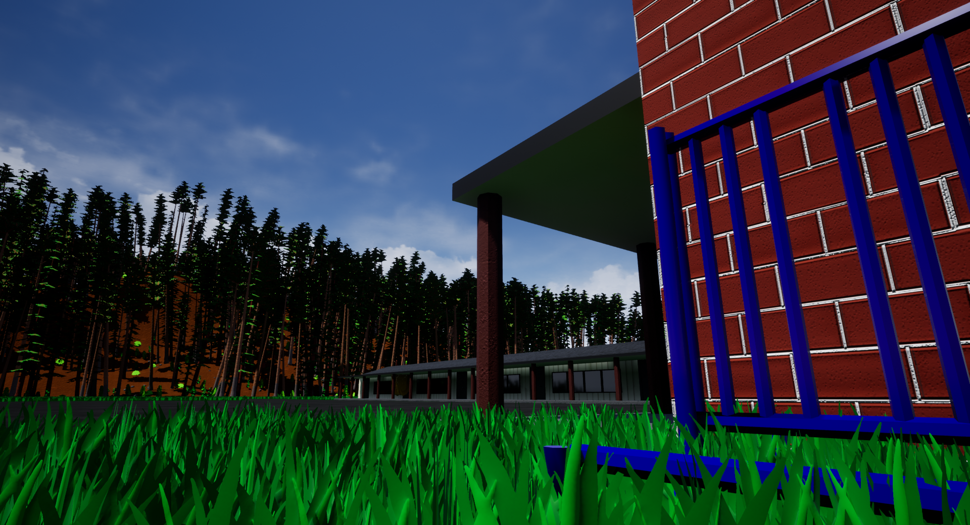 A view from the grass of a forest across from a building